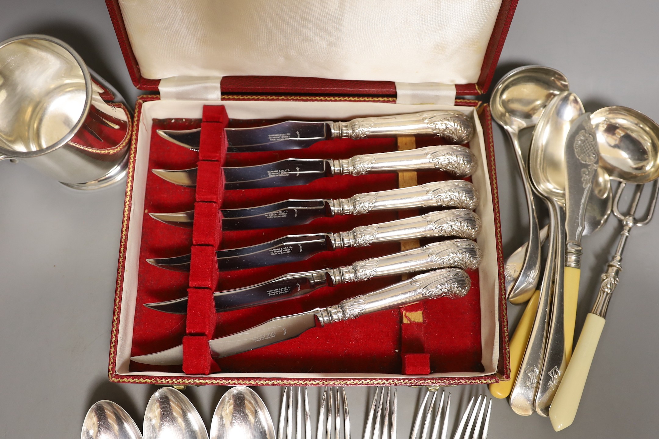 A cased set Garrard pistol handled steak knives, other plated cutlery and a plated mug